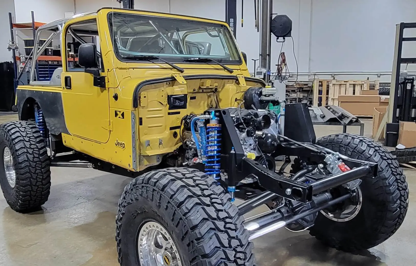 A yellow jeep is parked in the garage.